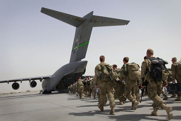 U.S. soldiers walk into a U.S. military plane, as they leave Afghanistan, at the U.S. base in Bagram, north of Kabul, Afghanistan on Thursday, July 14, 2011.
